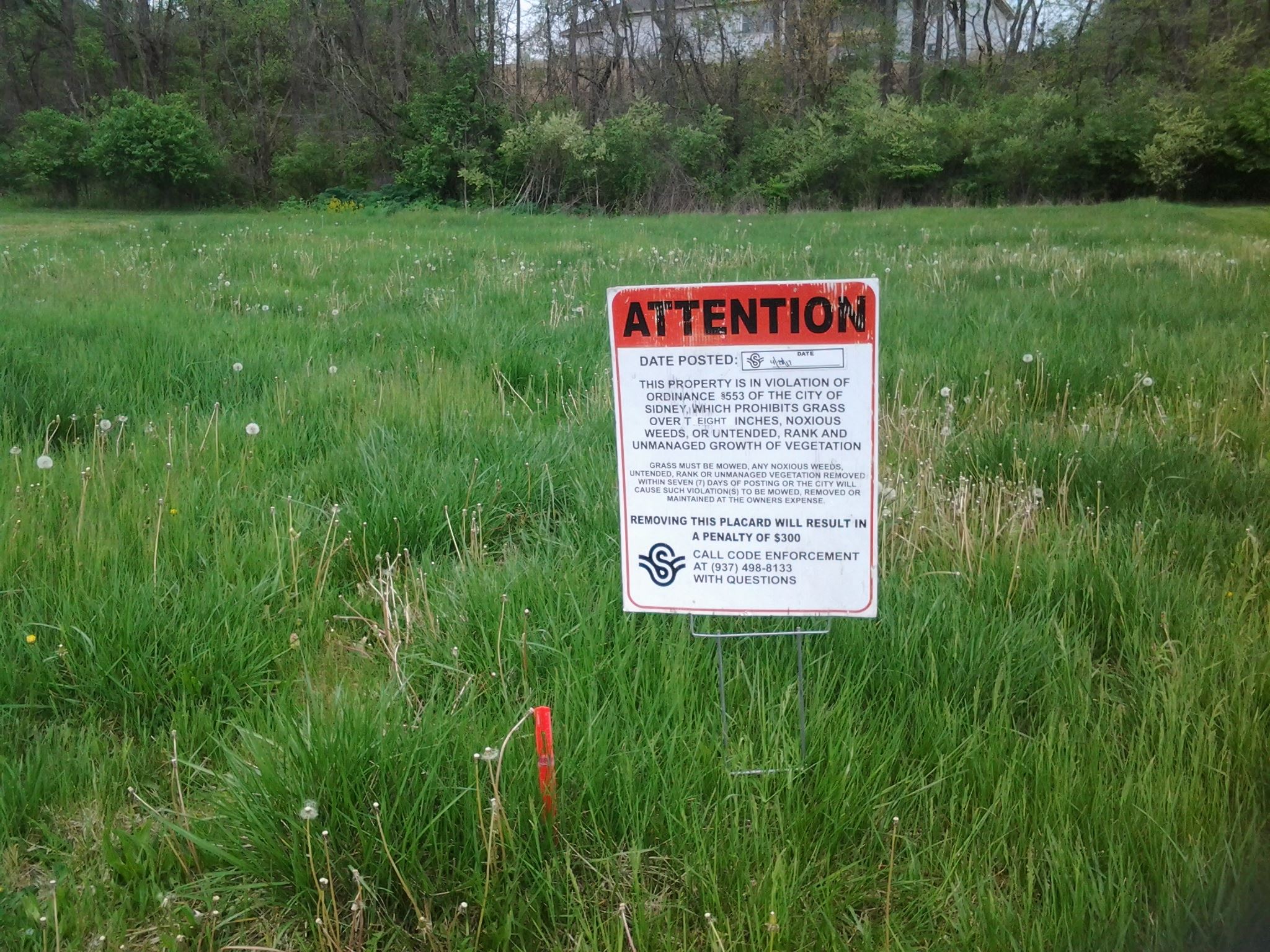 Violation notice posted in tall grass