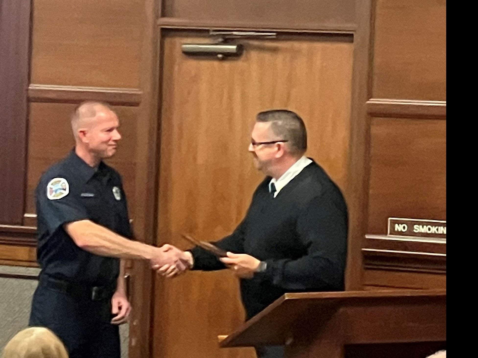 Firefighter of the Year Scott Marchal receives his award from Fire Chief Chad Hollinger